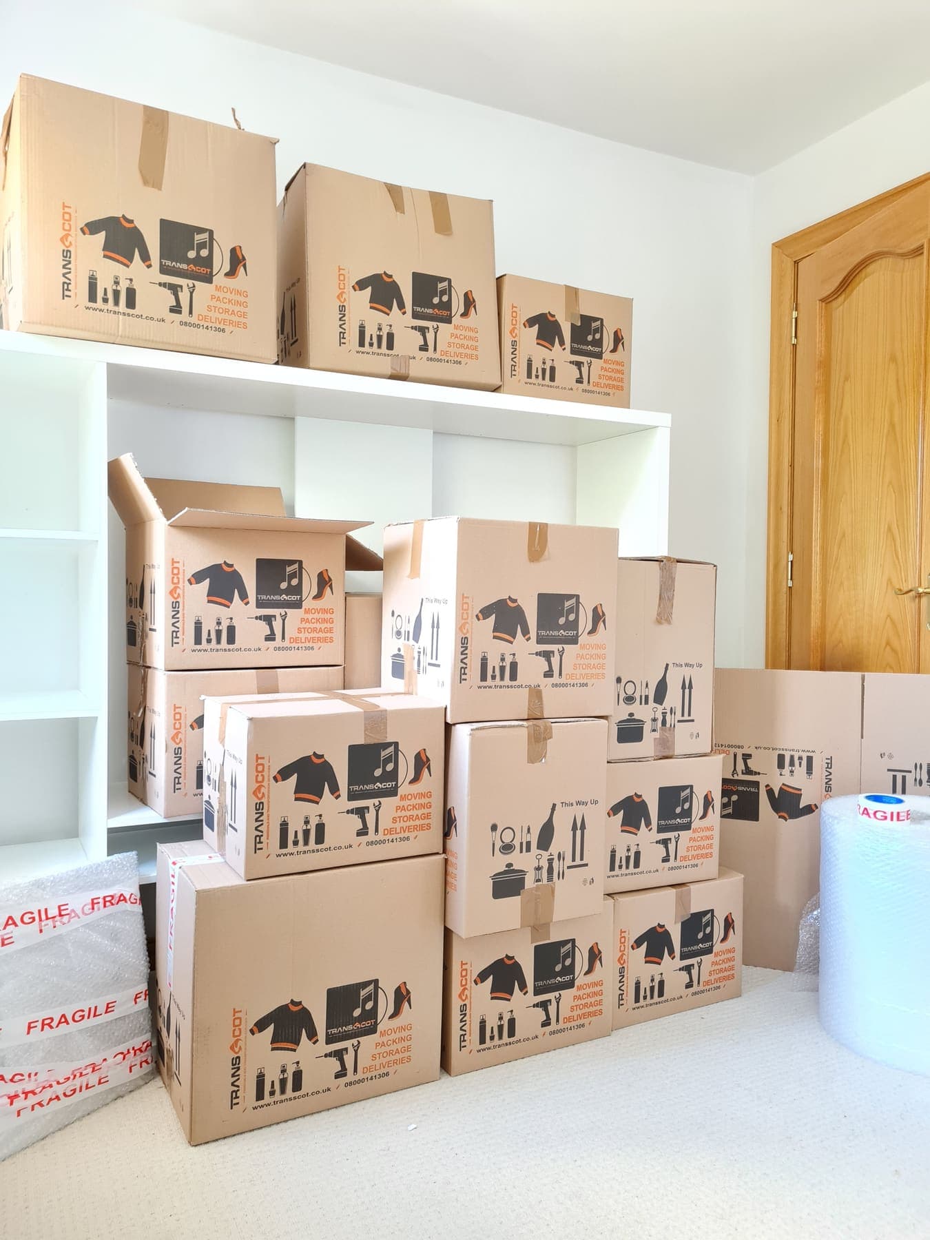 TransScot branded moving boxes packed and stacked in a customer's home