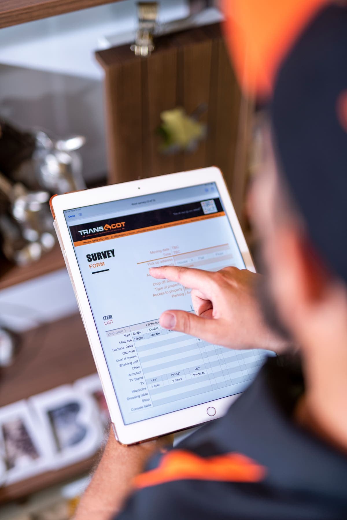 A TransScot surveyor filling in the survey form on a tablet during a home visit
