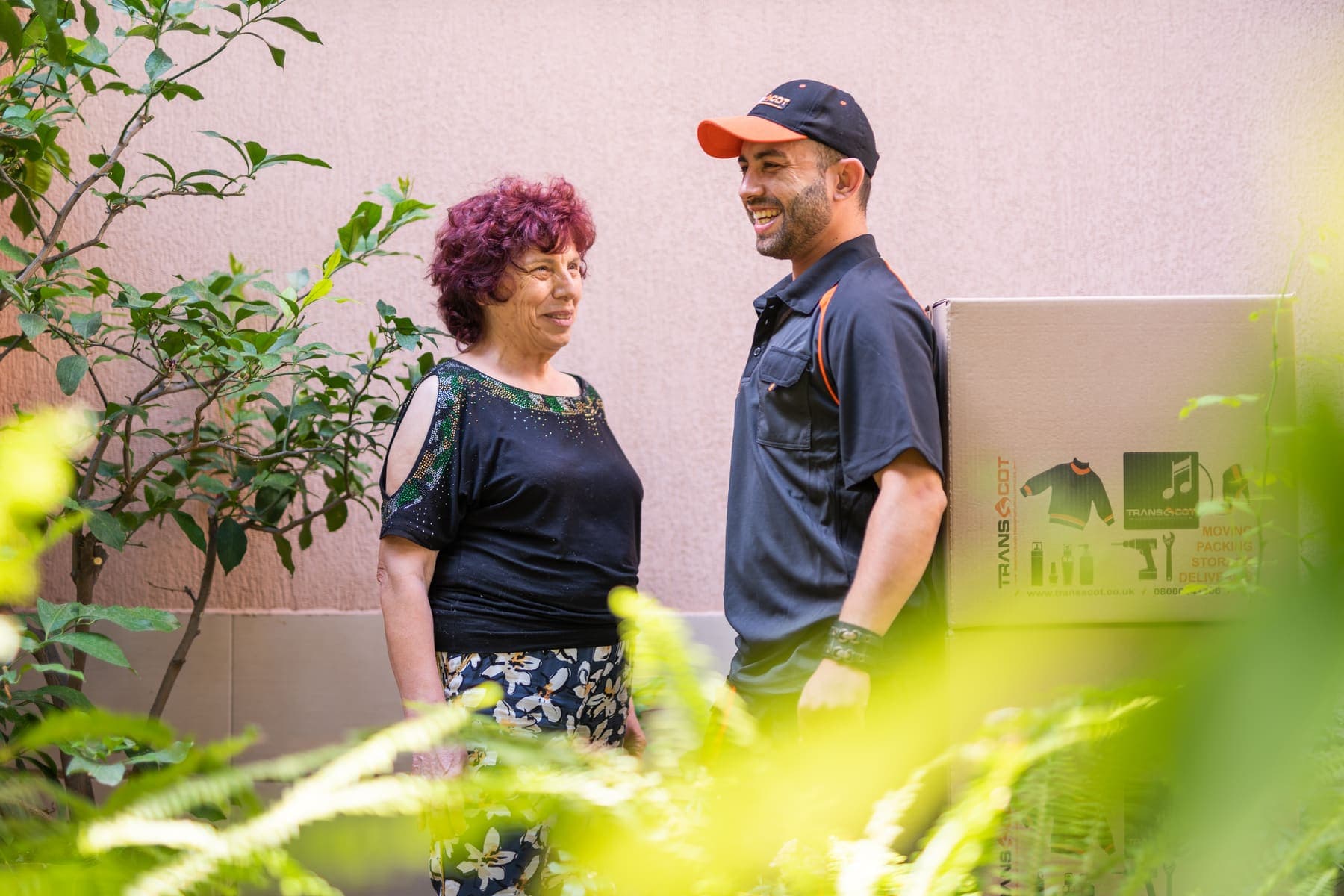 Two TransScot crew members at work outside a customer's sandstone home